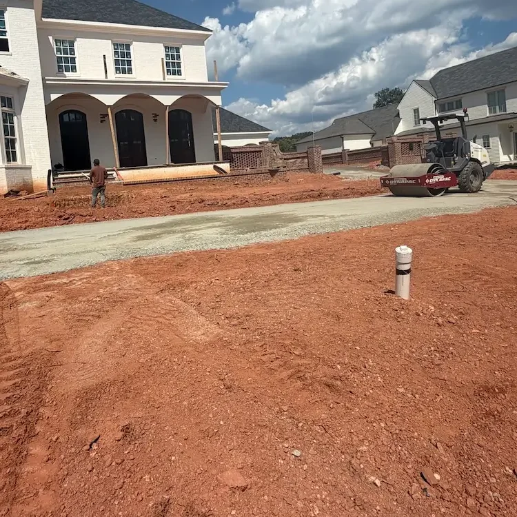 Residential driveway grading and base compaction during new home construction